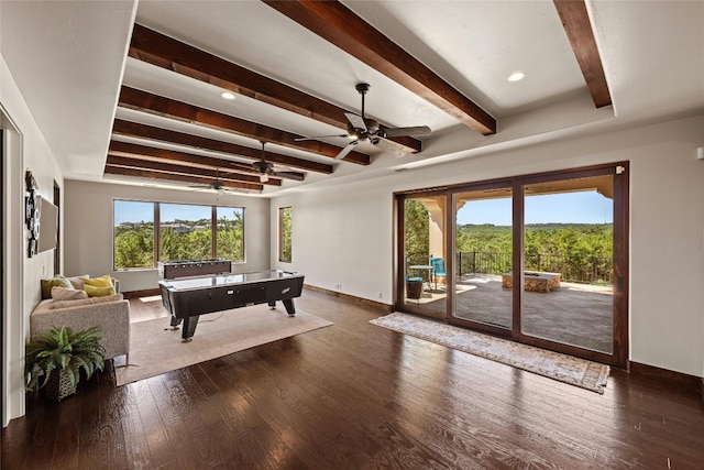 rec room with ceiling fan, dark hardwood / wood-style flooring, and beam ceiling