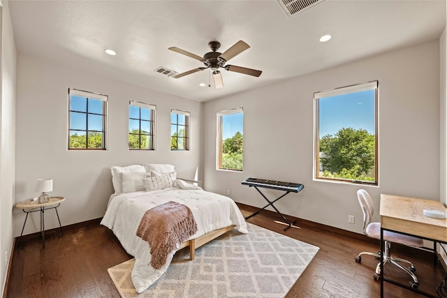 bedroom with ceiling fan and dark wood-type flooring