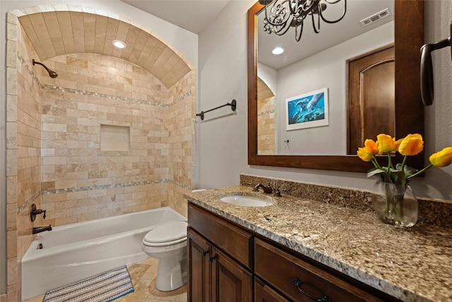 full bathroom featuring toilet, tiled shower / bath combo, tile patterned floors, and vanity