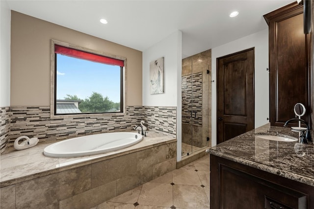 bathroom featuring independent shower and bath, tile patterned floors, and vanity