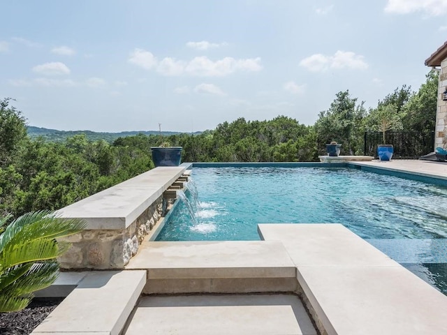 view of pool with pool water feature