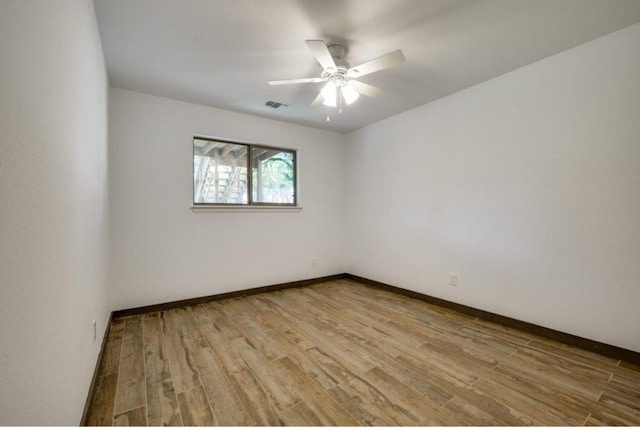 spare room with light hardwood / wood-style floors and ceiling fan