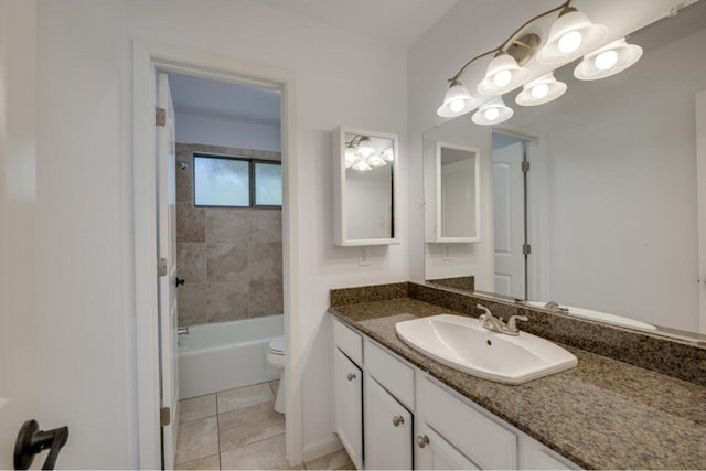 full bathroom featuring tile patterned flooring, vanity, toilet, and tiled shower / bath