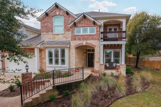 view of front of home featuring a balcony and a garage