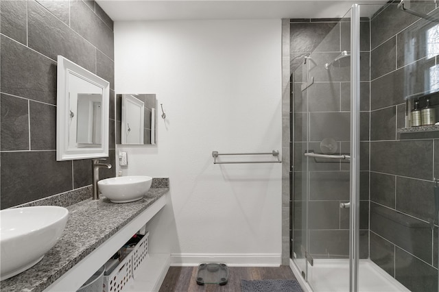 bathroom featuring vanity, hardwood / wood-style flooring, and walk in shower