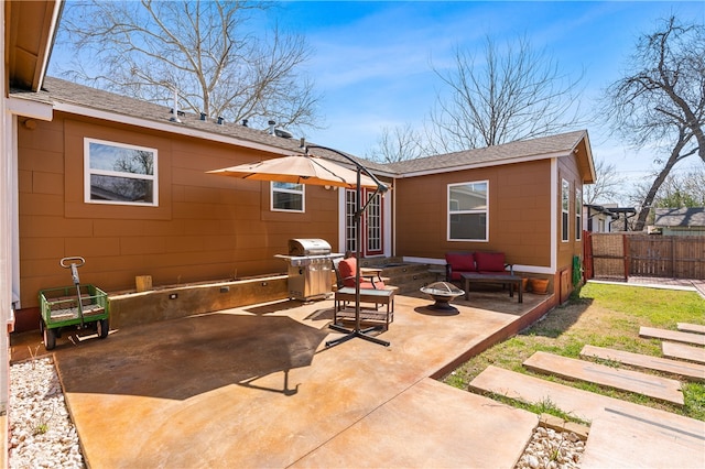 view of patio with a grill and an outdoor living space with a fire pit