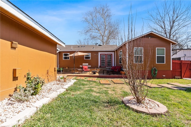 rear view of property with french doors, a lawn, and a patio area