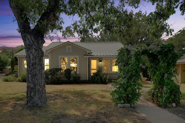 ranch-style home featuring a yard