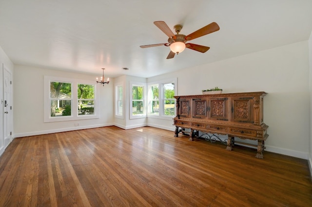 unfurnished room with wood-type flooring and ceiling fan with notable chandelier