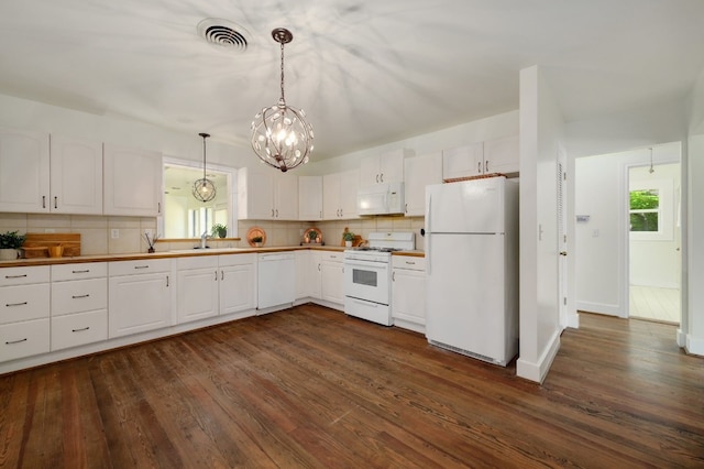 kitchen featuring white appliances, sink, backsplash, and dark hardwood / wood-style flooring