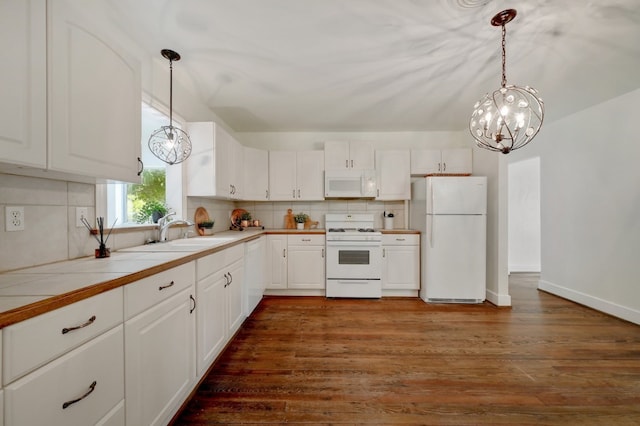 kitchen with decorative light fixtures, dark hardwood / wood-style flooring, and white appliances