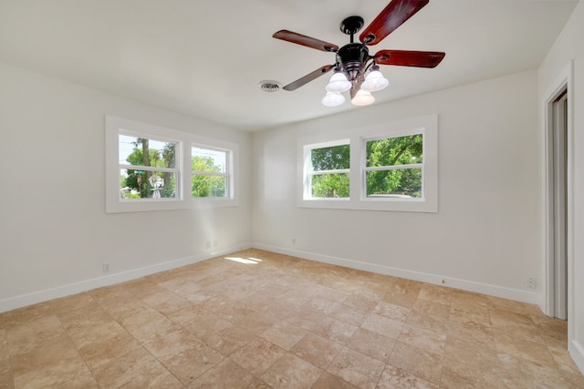 tiled empty room with ceiling fan