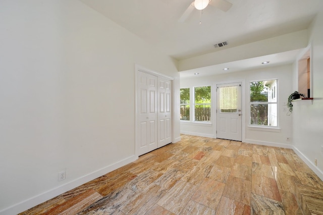 entrance foyer with ceiling fan