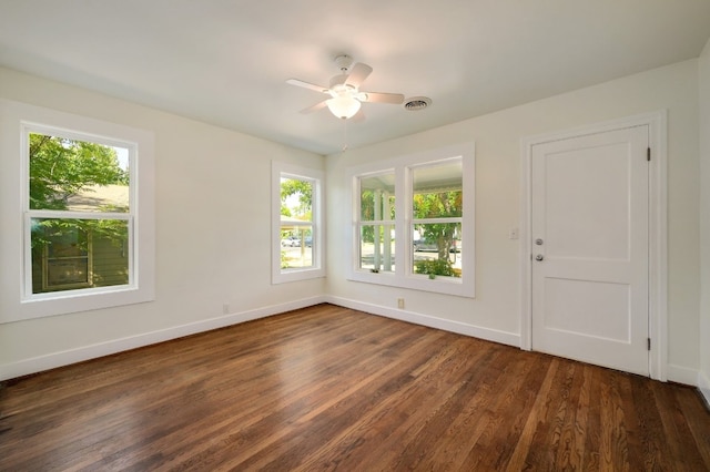 spare room with dark hardwood / wood-style floors and ceiling fan