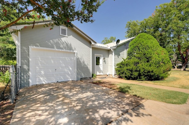 view of front of property with a garage and a front yard