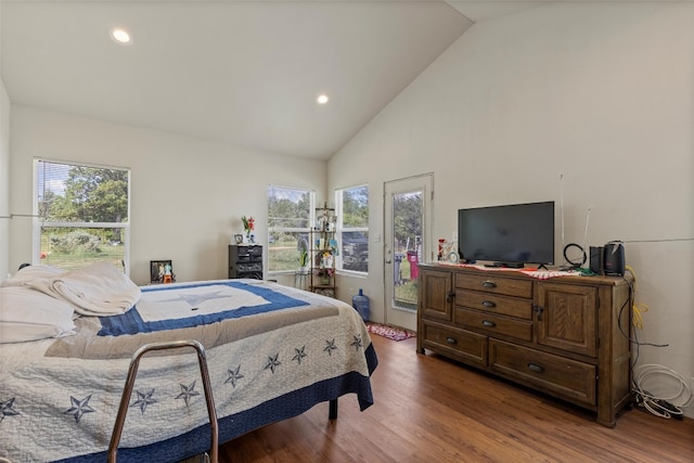 bedroom with wood-type flooring, multiple windows, and high vaulted ceiling