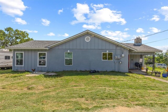 222 Pope Bnd N, Cedar Creek, TX 78612 - back of house with board and batten siding, a yard, and a shingled roof