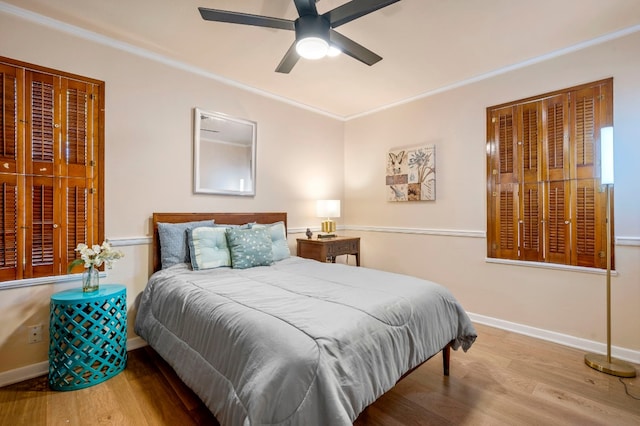 bedroom featuring crown molding, hardwood / wood-style floors, and ceiling fan