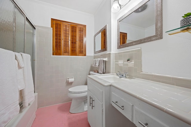 full bathroom with shower / tub combination, tile walls, vanity, toilet, and crown molding