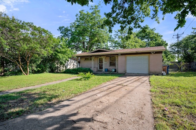 ranch-style home featuring a garage and a front yard