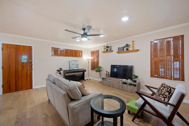 living room featuring ornamental molding, ceiling fan, and light wood-type flooring