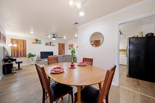 dining space featuring crown molding, light hardwood / wood-style flooring, and ceiling fan with notable chandelier