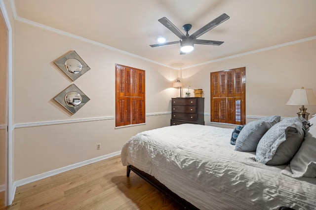 bedroom with ornamental molding, ceiling fan, and light wood-type flooring