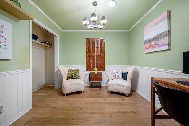 sitting room featuring an inviting chandelier, crown molding, and light hardwood / wood-style flooring