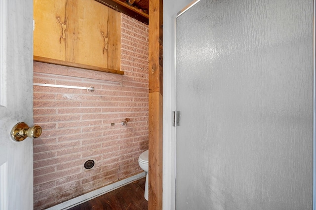 bathroom with hardwood / wood-style floors and toilet