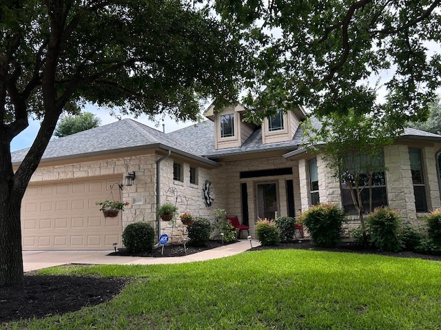 view of front facade featuring a front yard and a garage