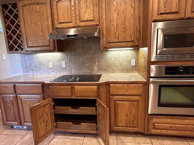 kitchen featuring decorative backsplash, light tile patterned floors, and stainless steel appliances