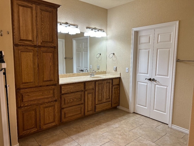 bathroom featuring tile patterned flooring and vanity