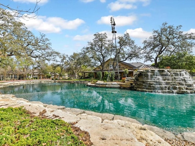 view of pool featuring a water view