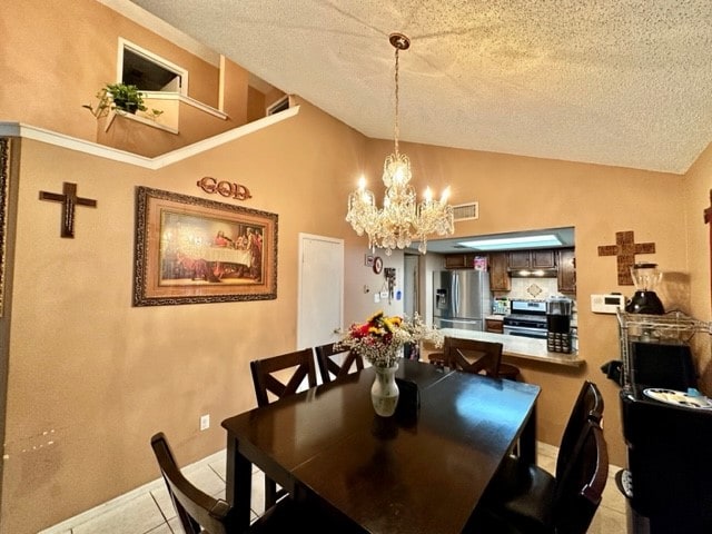 dining space with a textured ceiling, lofted ceiling, light tile patterned floors, and an inviting chandelier