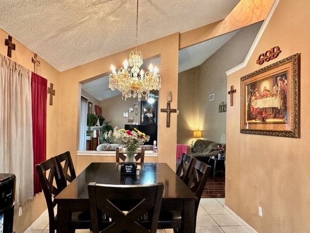 dining area featuring a notable chandelier, a textured ceiling, and light tile patterned flooring