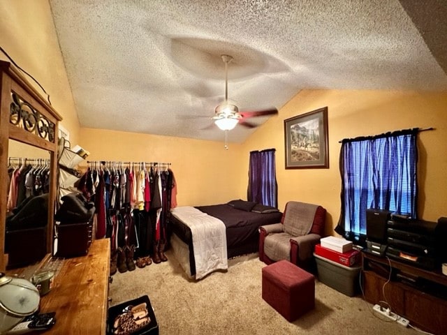 bedroom featuring carpet, a closet, a textured ceiling, and ceiling fan