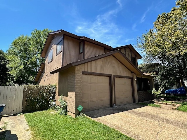 5509 Teri Rd, Austin, TX 78744 - view of property exterior with a garage, concrete driveway, and fence