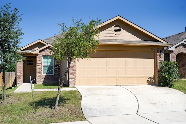 view of front of property featuring a garage and a front lawn