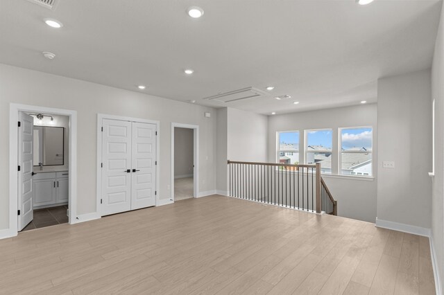 unfurnished room with light wood-type flooring