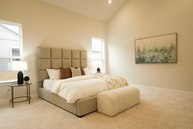 bedroom with light carpet and high vaulted ceiling