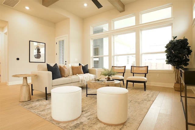 living room with beam ceiling and light hardwood / wood-style flooring