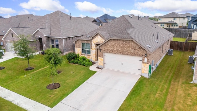 view of front of property featuring a garage, a front lawn, and central air condition unit