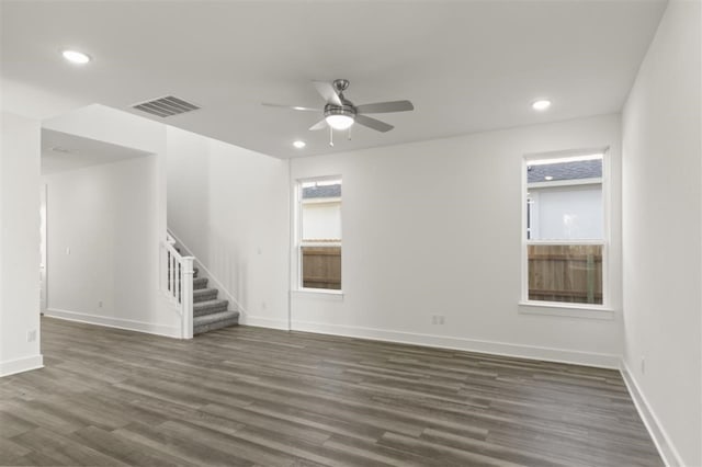 unfurnished room with ceiling fan and dark wood-type flooring