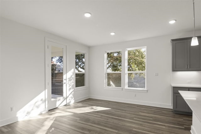 unfurnished dining area featuring dark hardwood / wood-style flooring