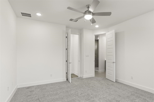 unfurnished bedroom featuring ceiling fan and light colored carpet