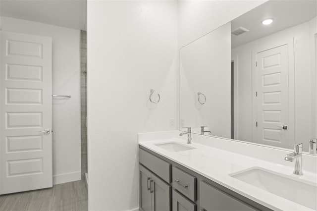 bathroom with hardwood / wood-style flooring and vanity