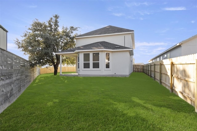 rear view of house with a yard