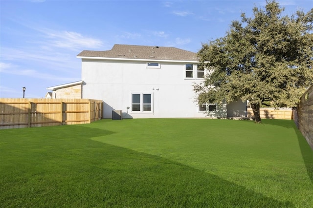 rear view of house featuring a lawn