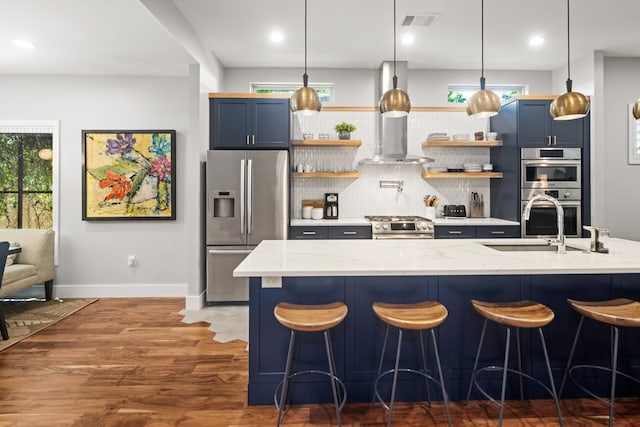 kitchen featuring light stone countertops, blue cabinetry, and appliances with stainless steel finishes