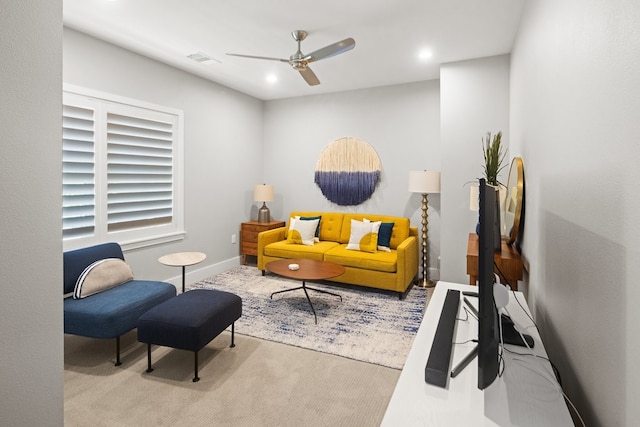 carpeted living room with ceiling fan